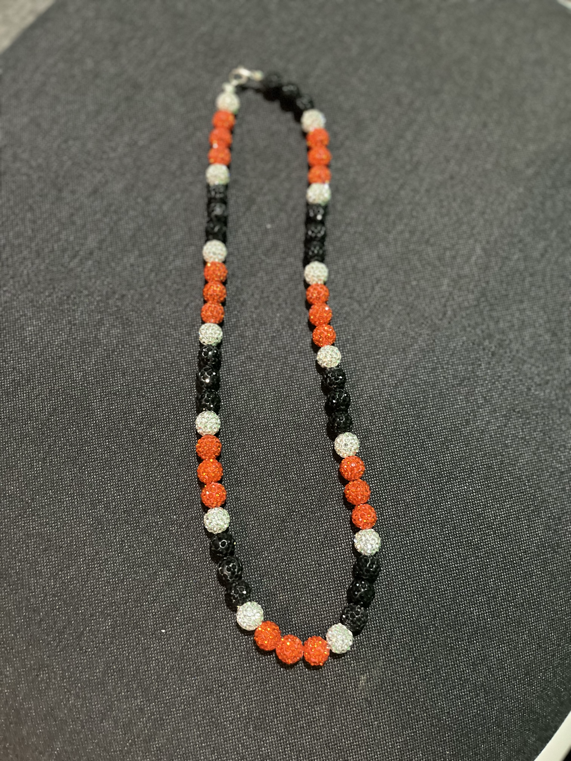 orange black and white beaded necklace